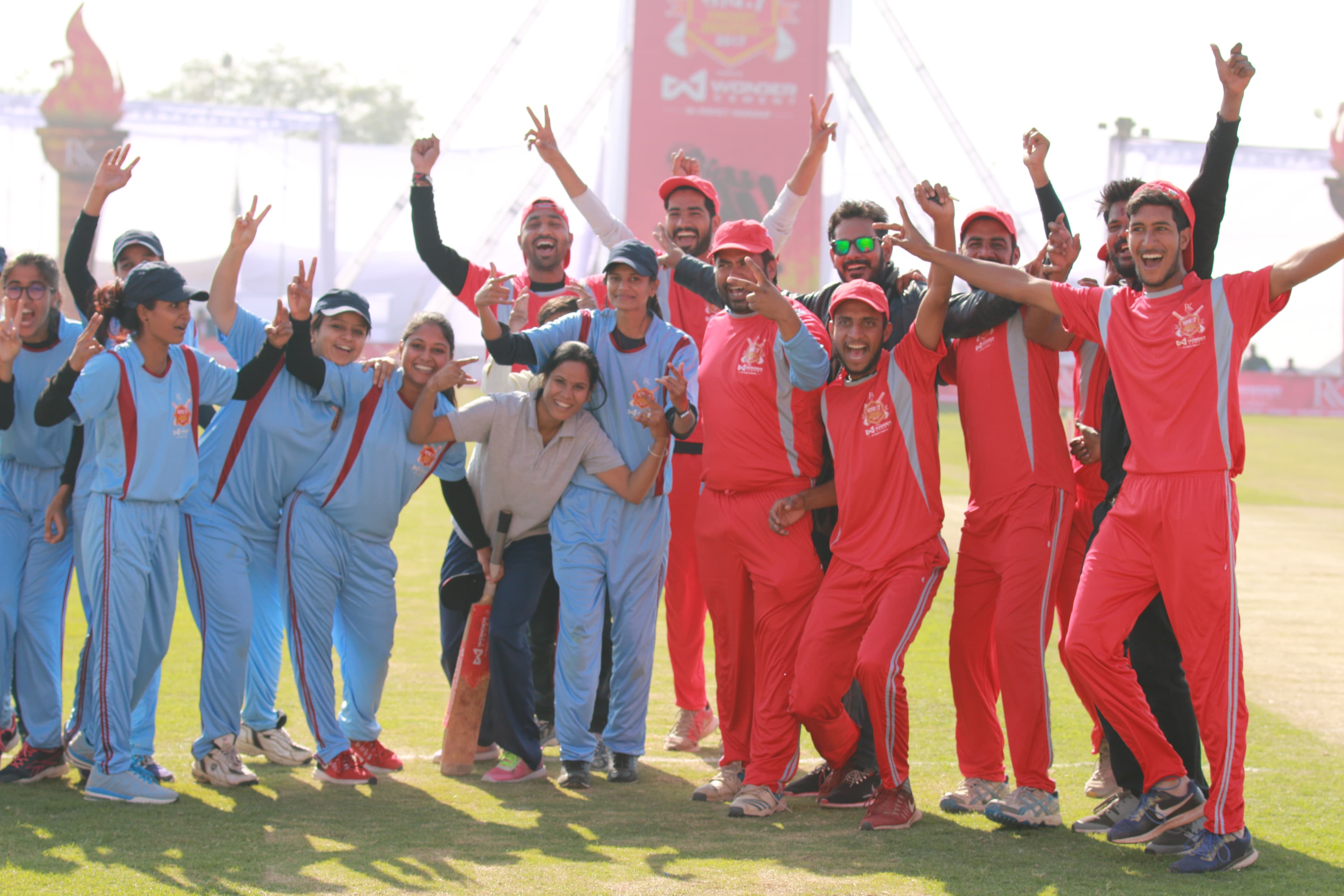 Mixed men's and women's team celebrating together