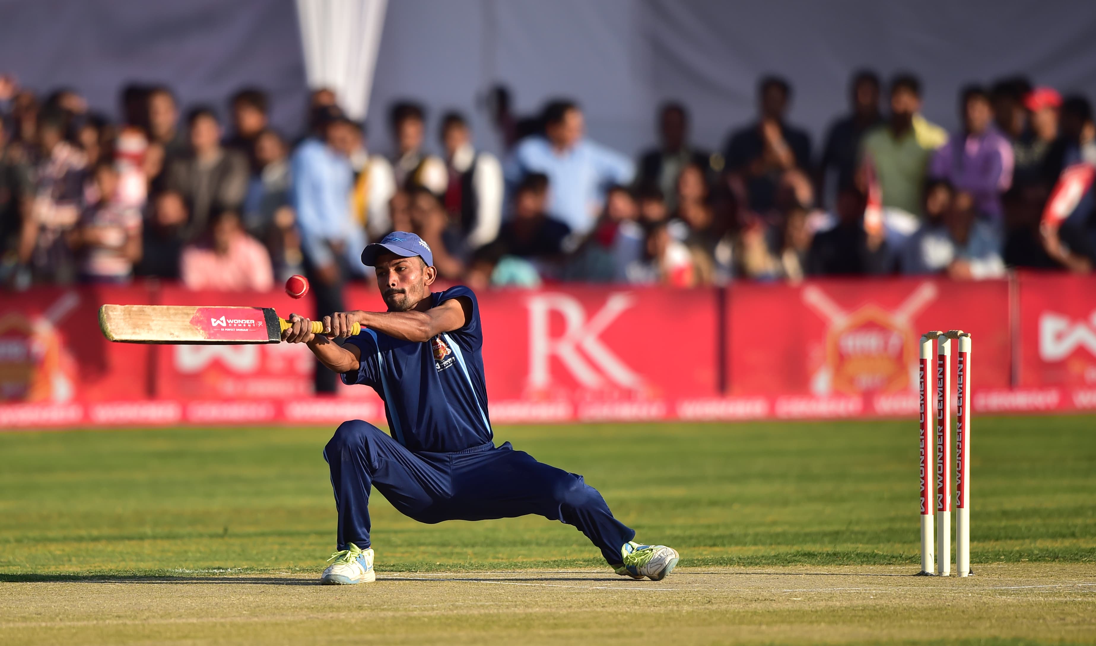 A batter plays a cut shot at a real साथ:7 match